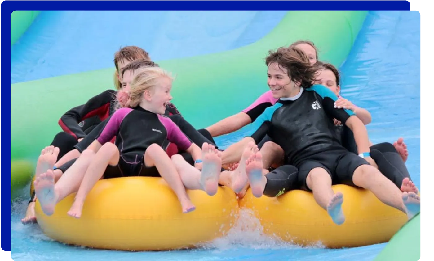 Group of children enjoying the slip and slide experience at Giant Slip and Slide Cornwall