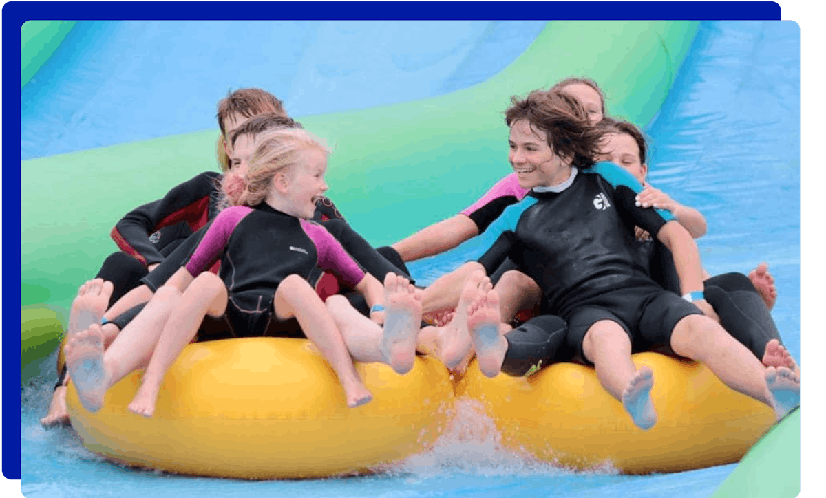 Group of children enjoying the slip and slide experience at Giant Slip and Slide Cornwall