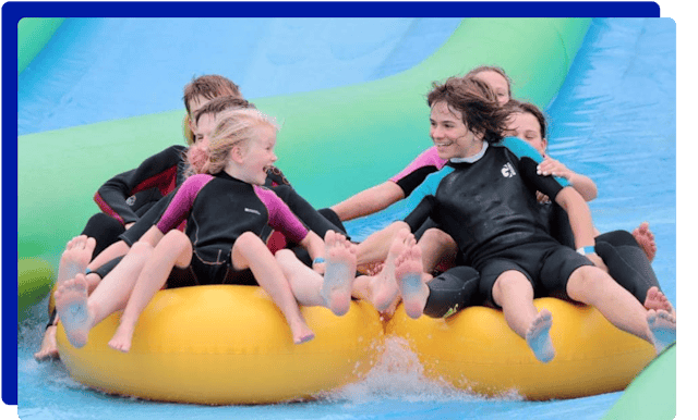 Group of children enjoying the slip and slide experience at Giant Slip and Slide Cornwall