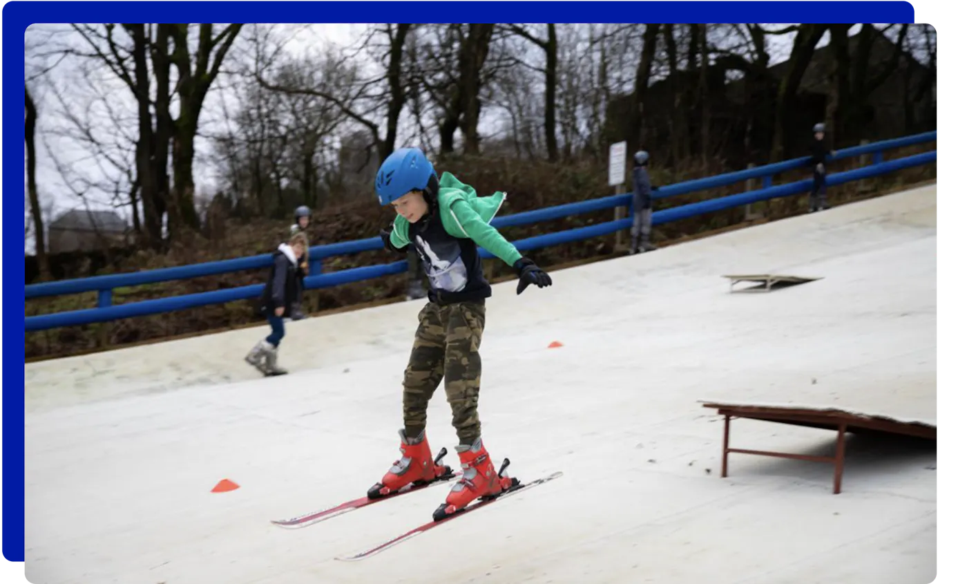 Boy skiing down the ski slopes at The Hill, Ski Rossendale in Lancashire