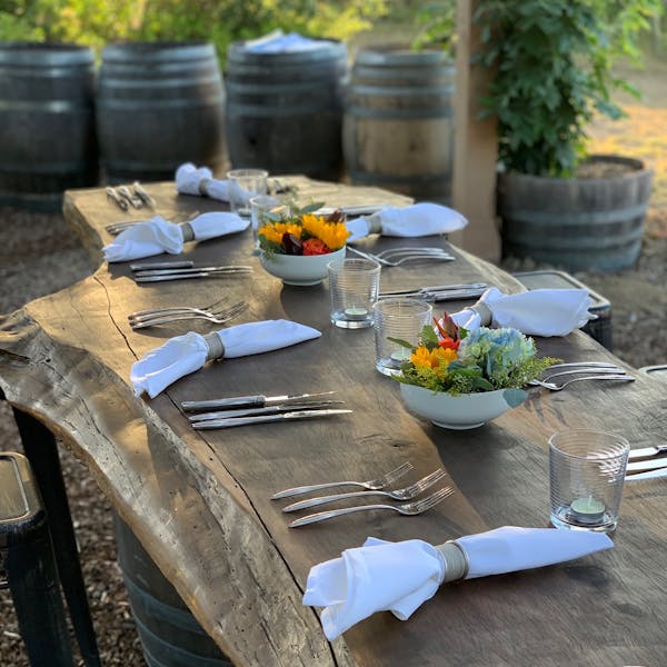 rustic wooden table setting with flower arrangements