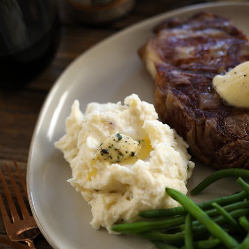 Mashed potatoes, steak, and Epicurean butter