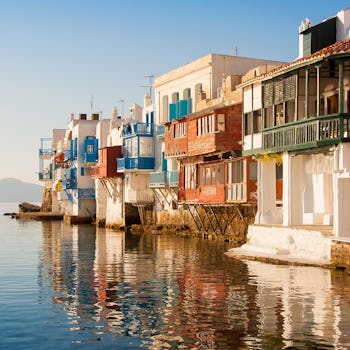 Grekiska hus precis vid vattnet, härligt badande i sol.