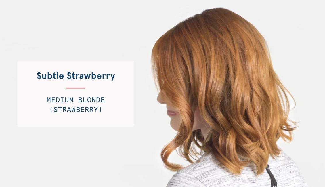 Image of woman with subtle strawberry custom red hair color, she has a medium blonde base with strawberry tones