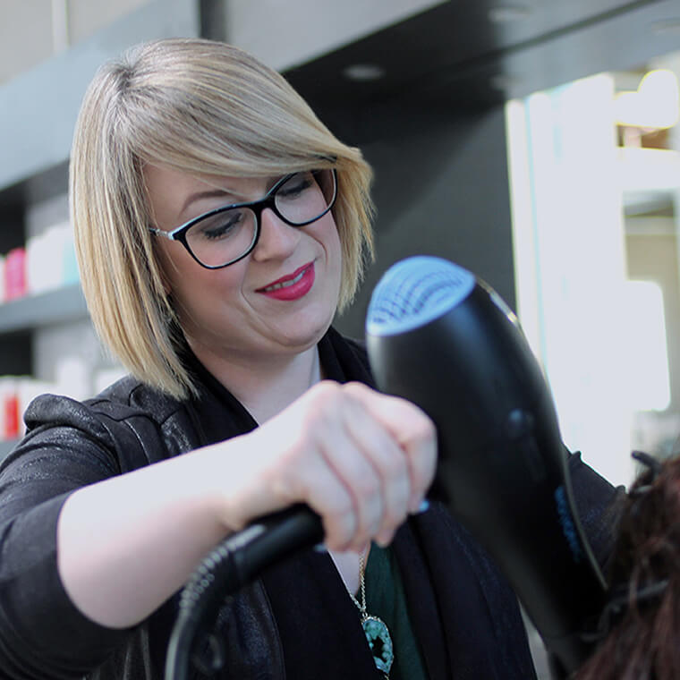 Image of esalon colorist Emily working on client's hair in the color studio