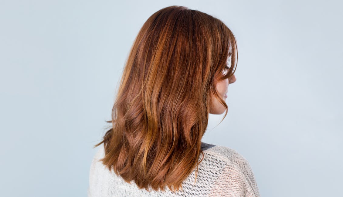 Image of esalon client with custom strawberry copper hair color trending in summer