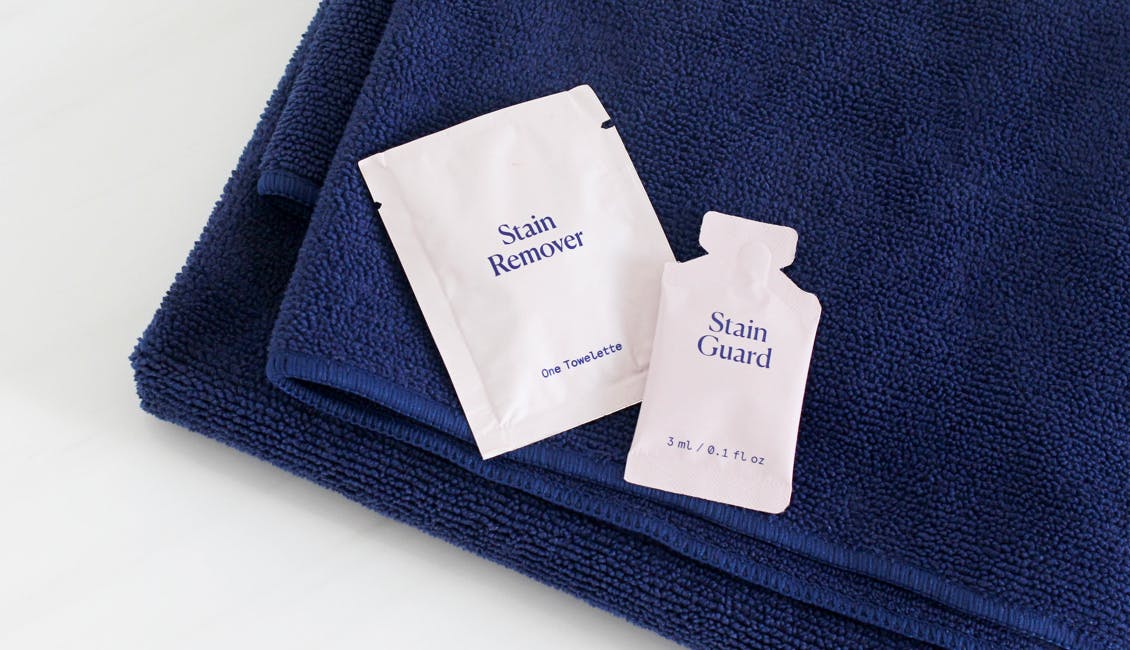 Image of eSalon's Stain Remover and Stain Guard on a microfiber hair towel to help prevent and remove hair color stains when coloring hair at home