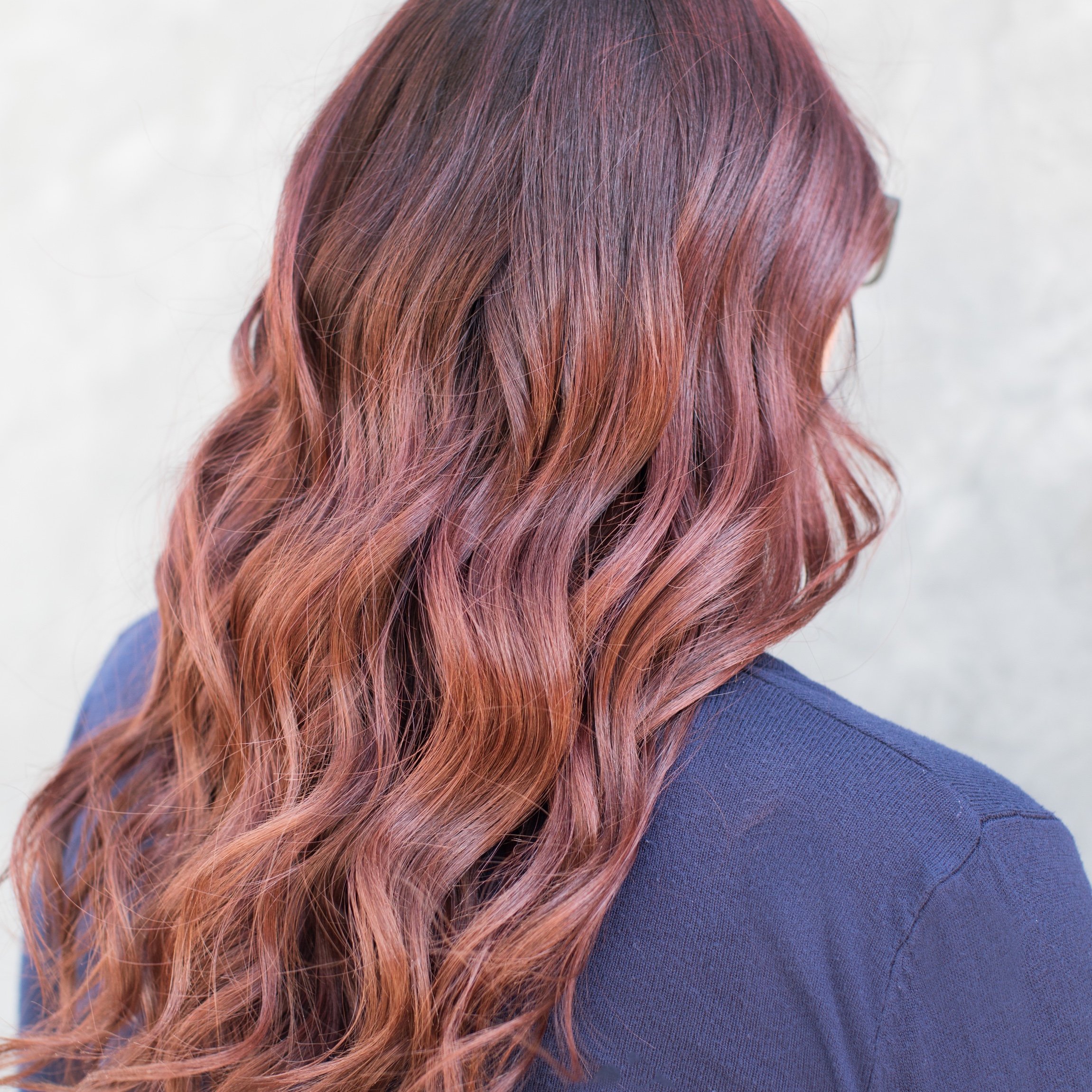 image of esalon client with trending custom warm auburn hair color for fall and winter