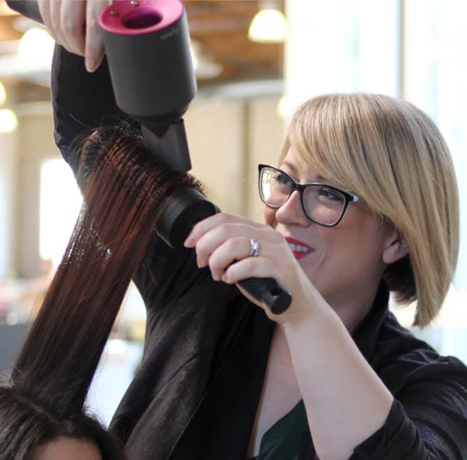 Image of esalon colorist giving client a blowout in the color studio