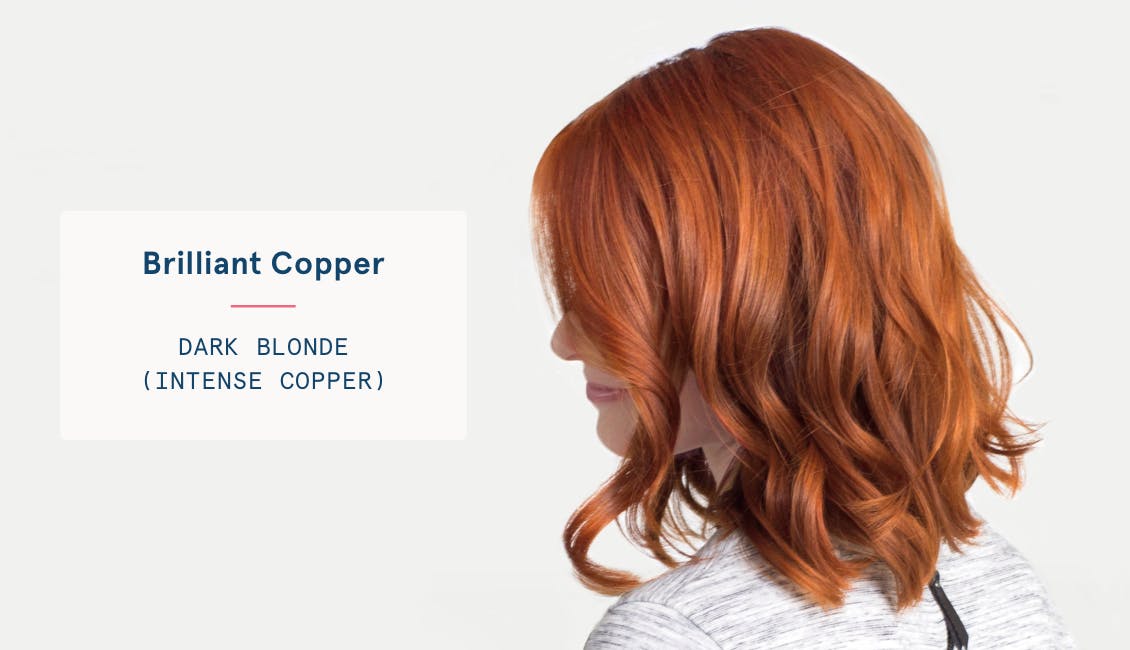 Image of woman with brilliant copper custom red hair color, she has dark blonde base with intense copper tones