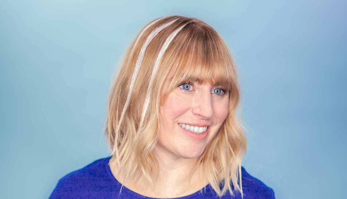 Image of colorist with strips of light set formula in hair to achieve balayage highlights at home with esalon