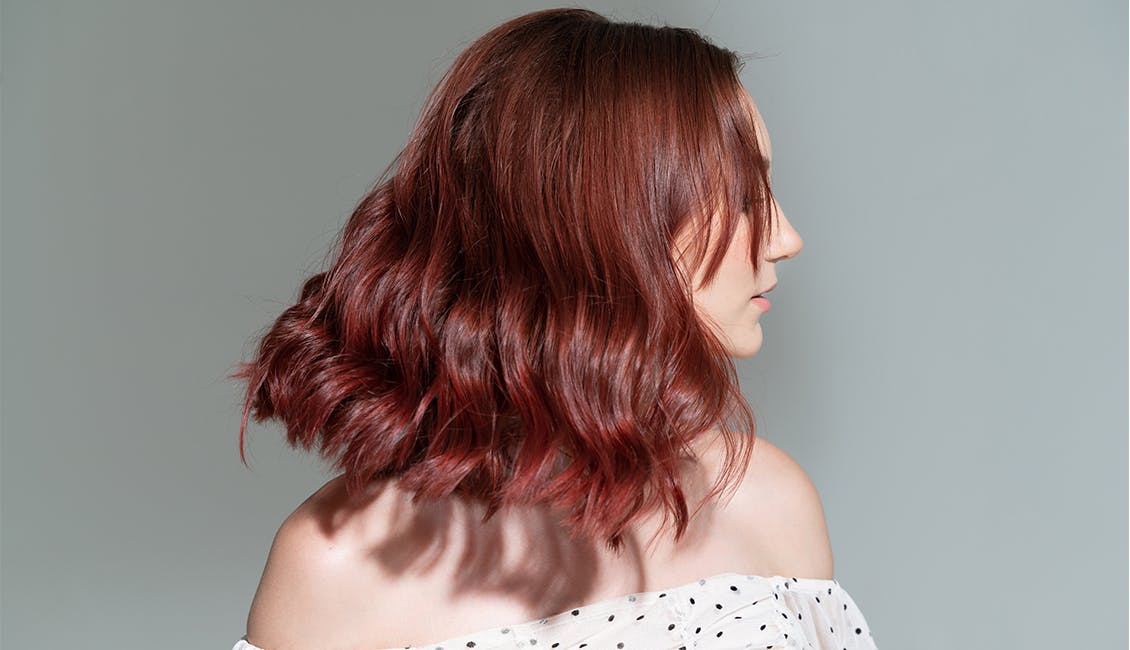 Woman with Deep Berry Red hair. 