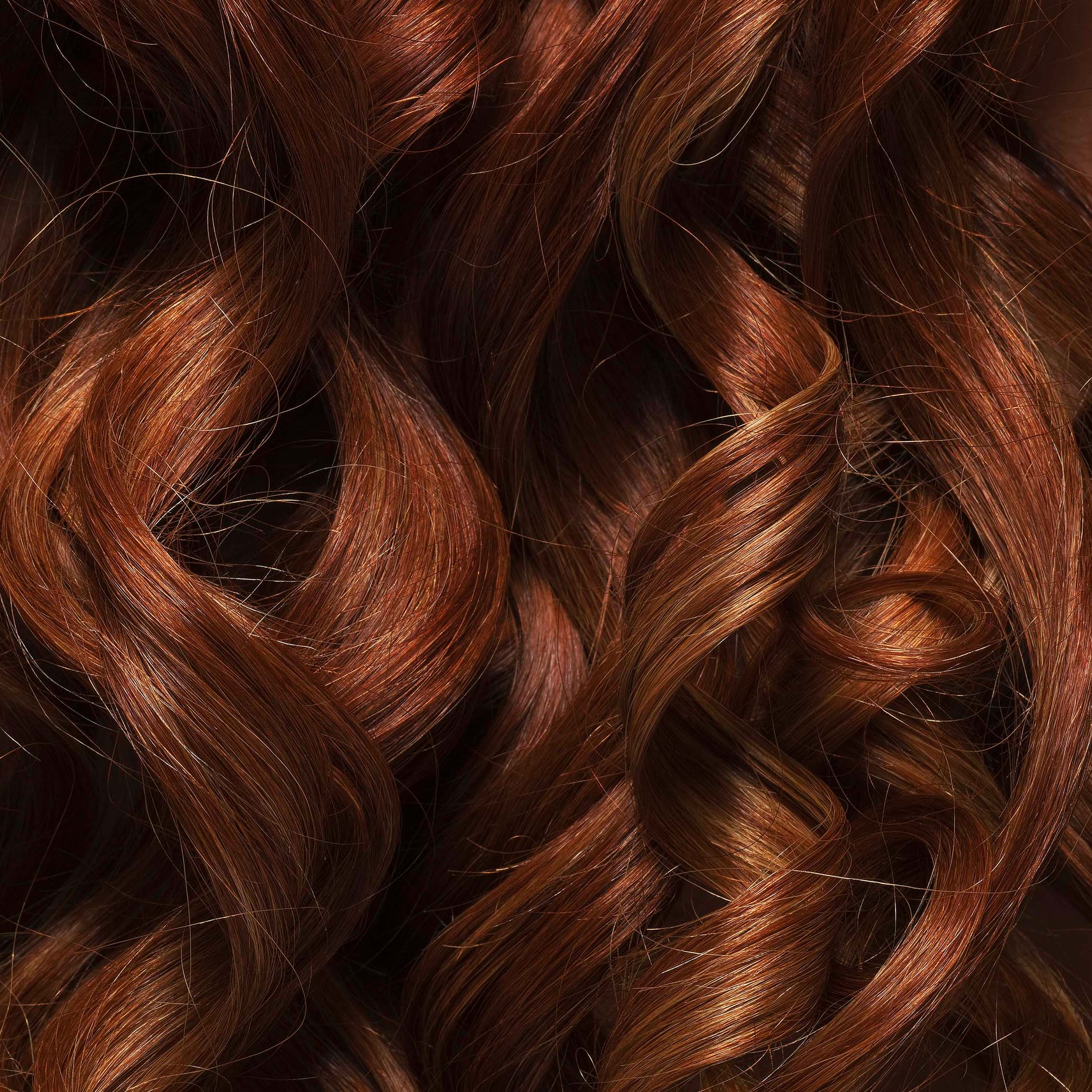 Thick brunette hair with ringlet curls.