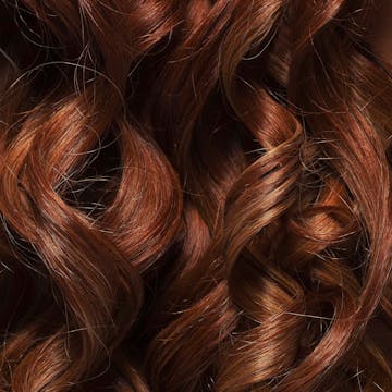 Thick brunette hair with ringlet curls.