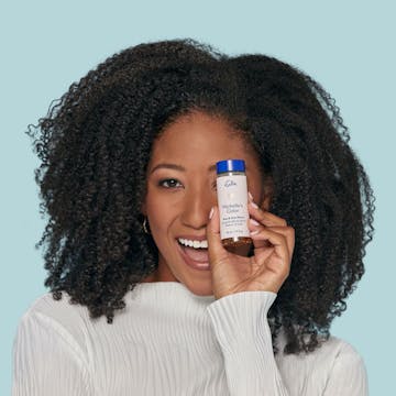 eSalon client holding her custom ammonia-free demi-permanent hair color