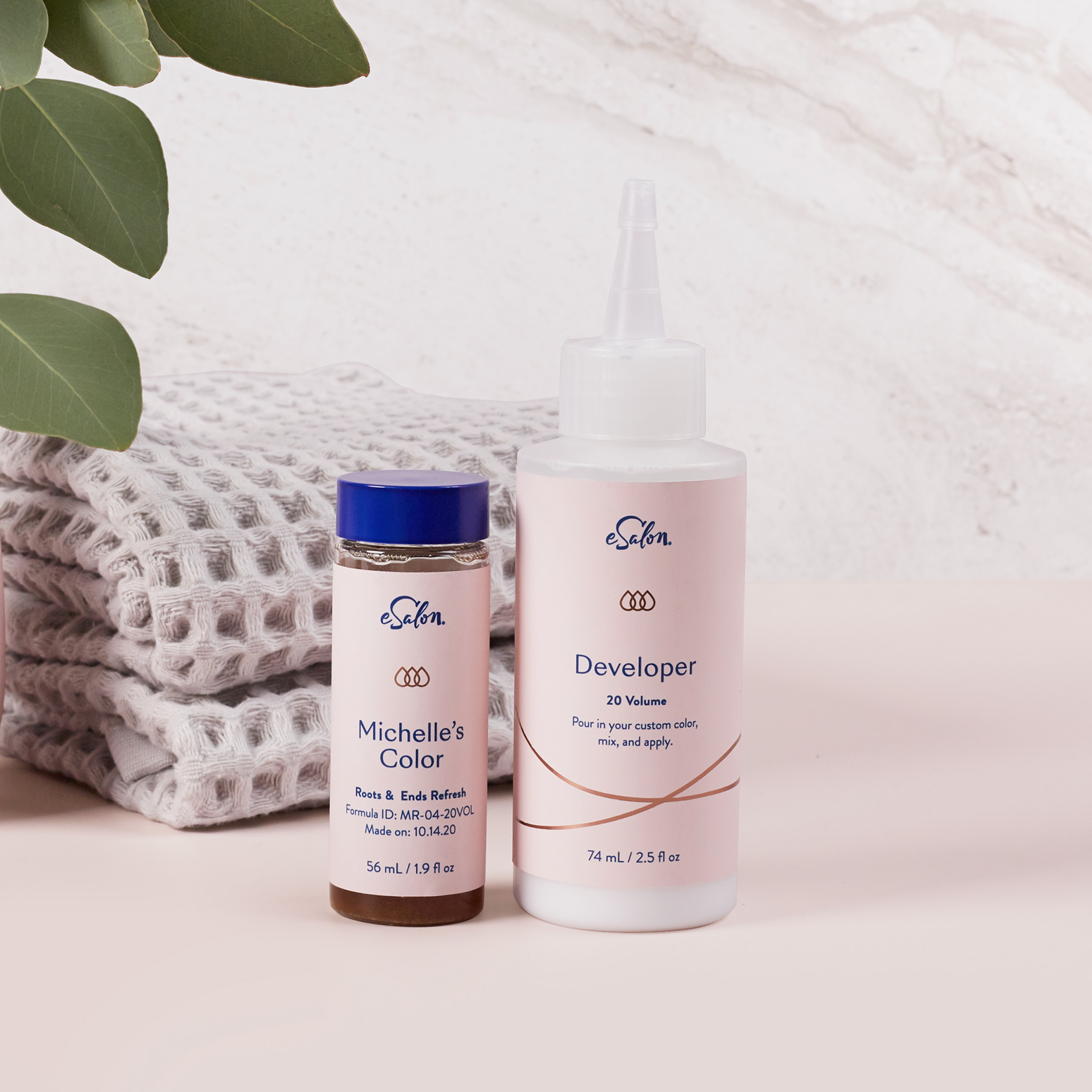 A bottle of hair color and hair developer on a bathroom counter