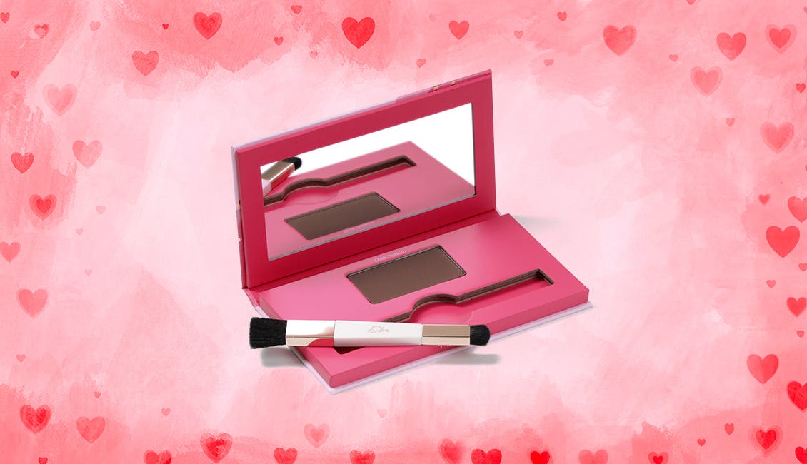 An open Conceal & Cover Root Powder palette with pink and red hearts in the background. 