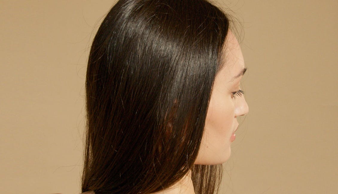 Woman with straight, shiny Luminous Brunette hair. 