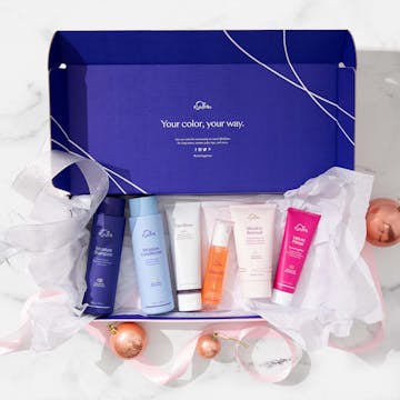 Box surrounded by ribbons and ornaments and filled with eSalon hair care 