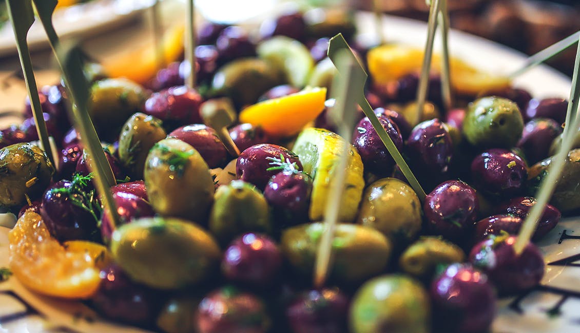 A mix of olives with citrus peels and herbs. 