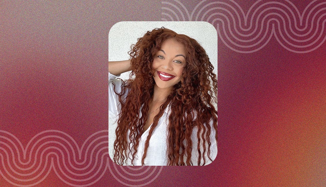 Smiling woman showcasing the Game Changer Cherry hair color trend.