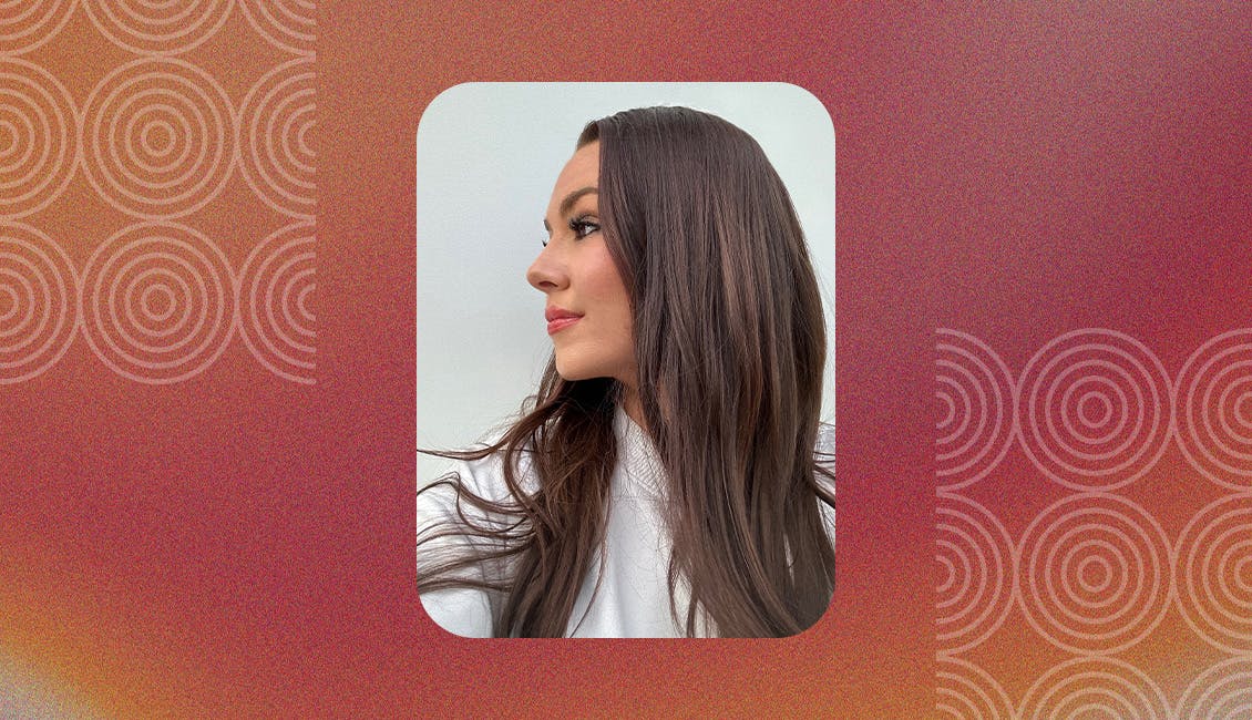 Woman showcasing the Mahogany Dreamer hair color trend.
