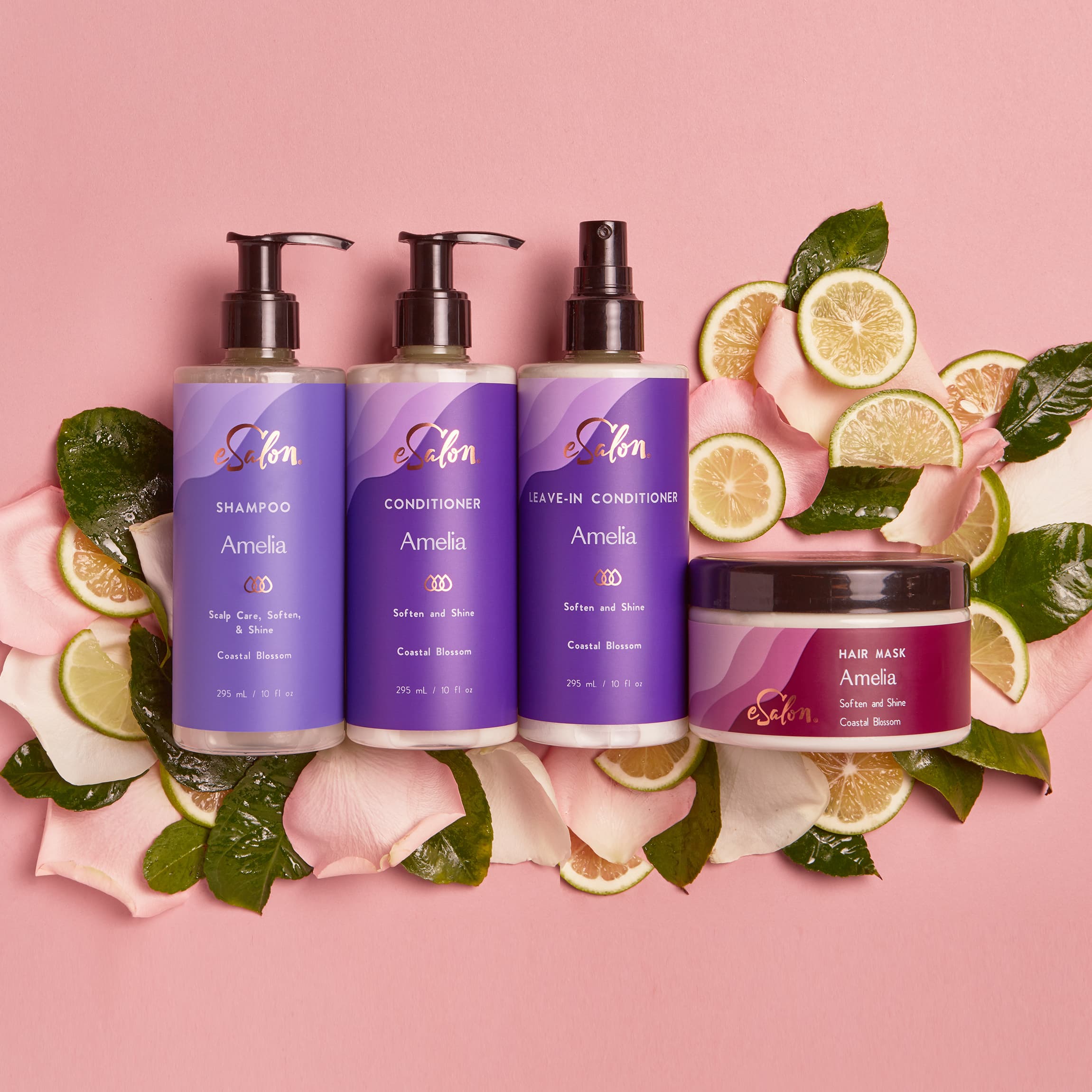 eSalon Custom Hair Care bottles sitting on top of fruit slices and flower petals. 