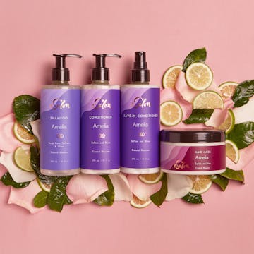 eSalon Custom Hair Care bottles sitting on top of fruit slices and flower petals.