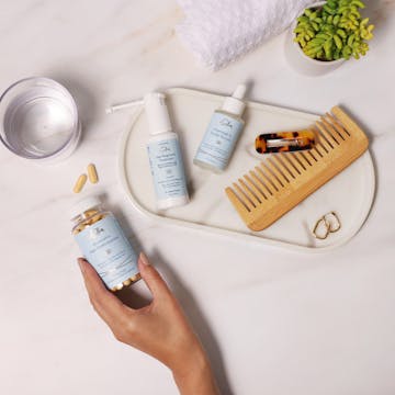 Bathroom counter with eSalon hair growth products.