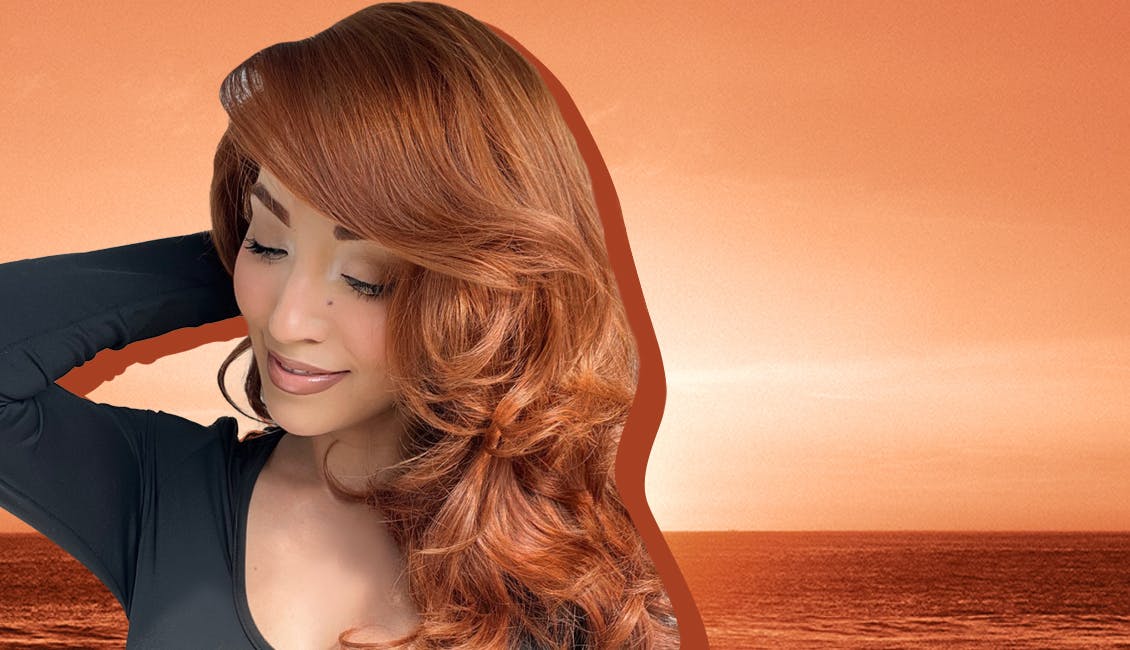 Woman with Sunset Red hair color and a sunset in the background. 