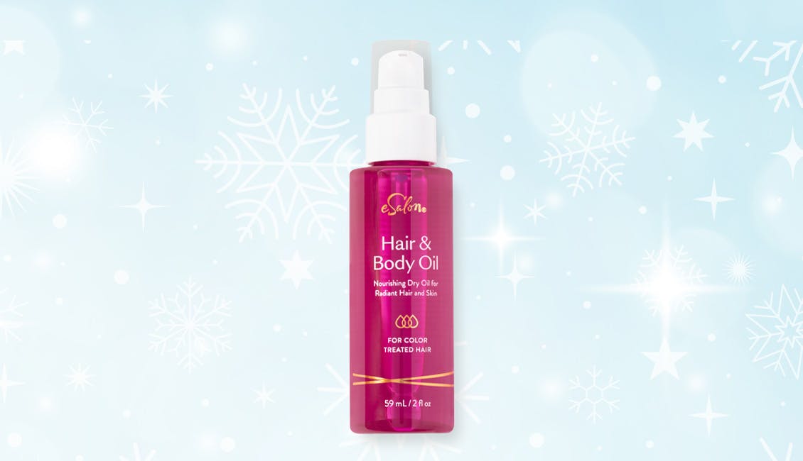 eSalon Hair & Body Oil bottle with a snowy background. 