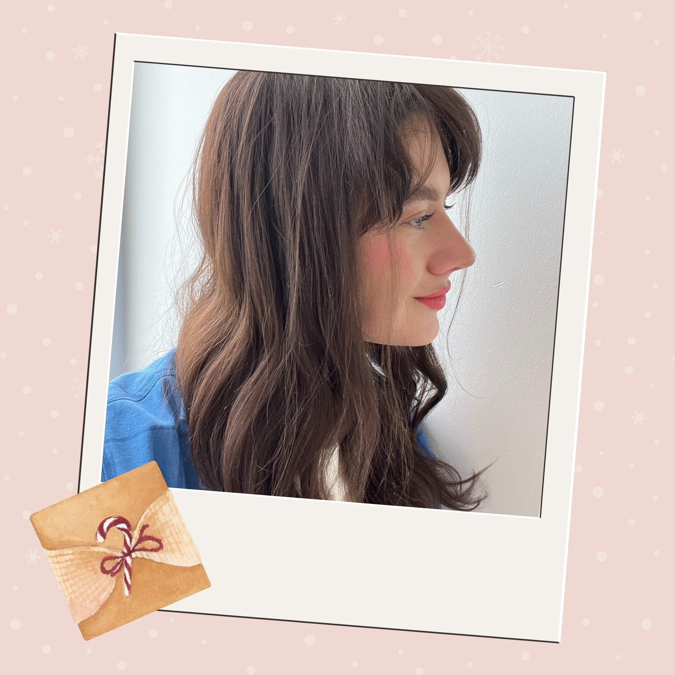 Woman with brunette hair next to a wrapped present.