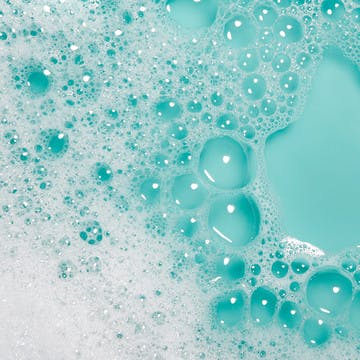 Image of shampoo suds on blue background