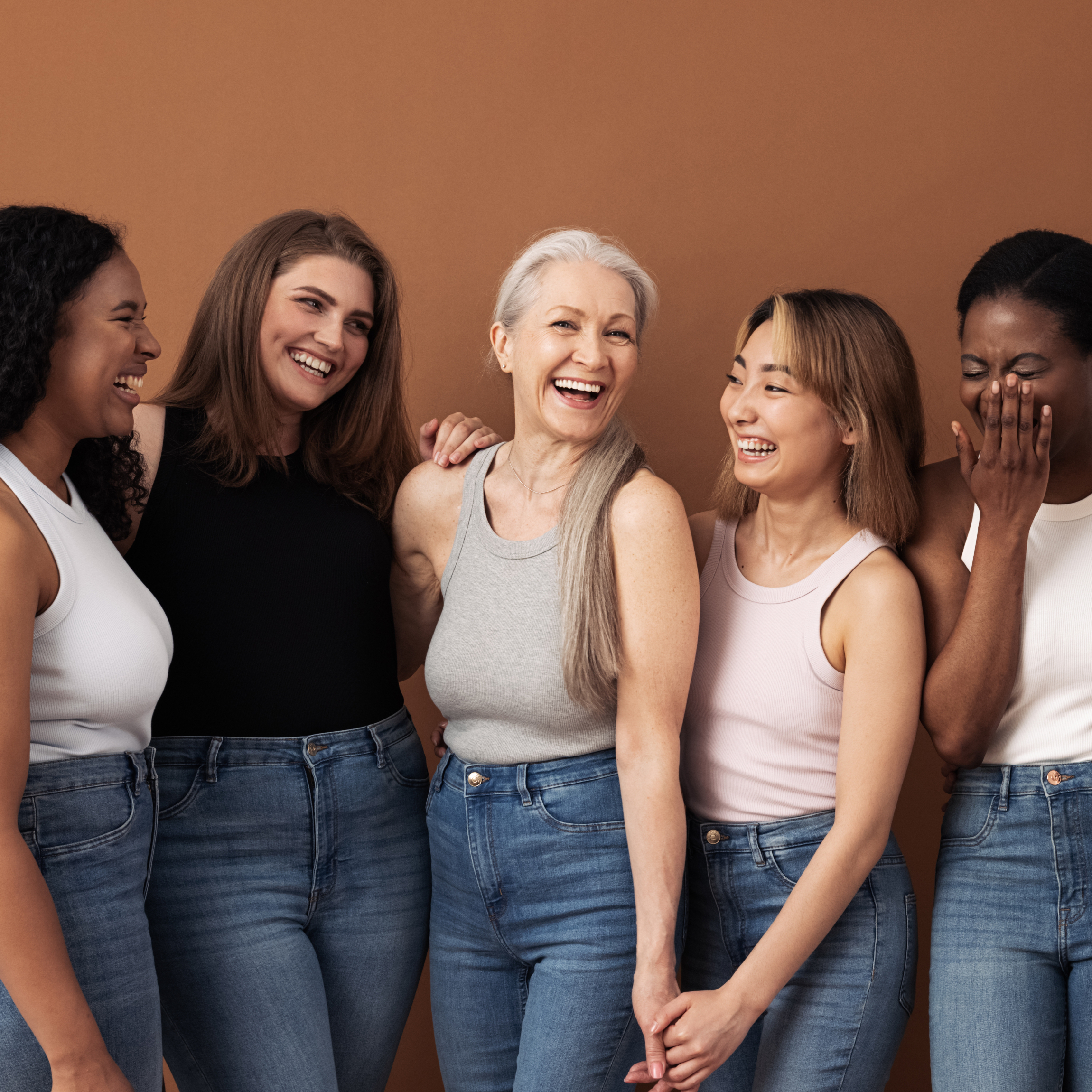 Group of smiling women in various age groups. 