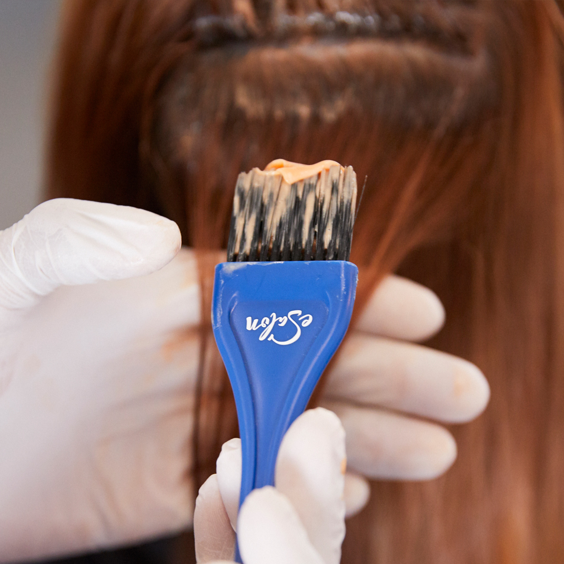 Woman get her hair colored a stunning copper hair color by one of eSalon's colorists. 