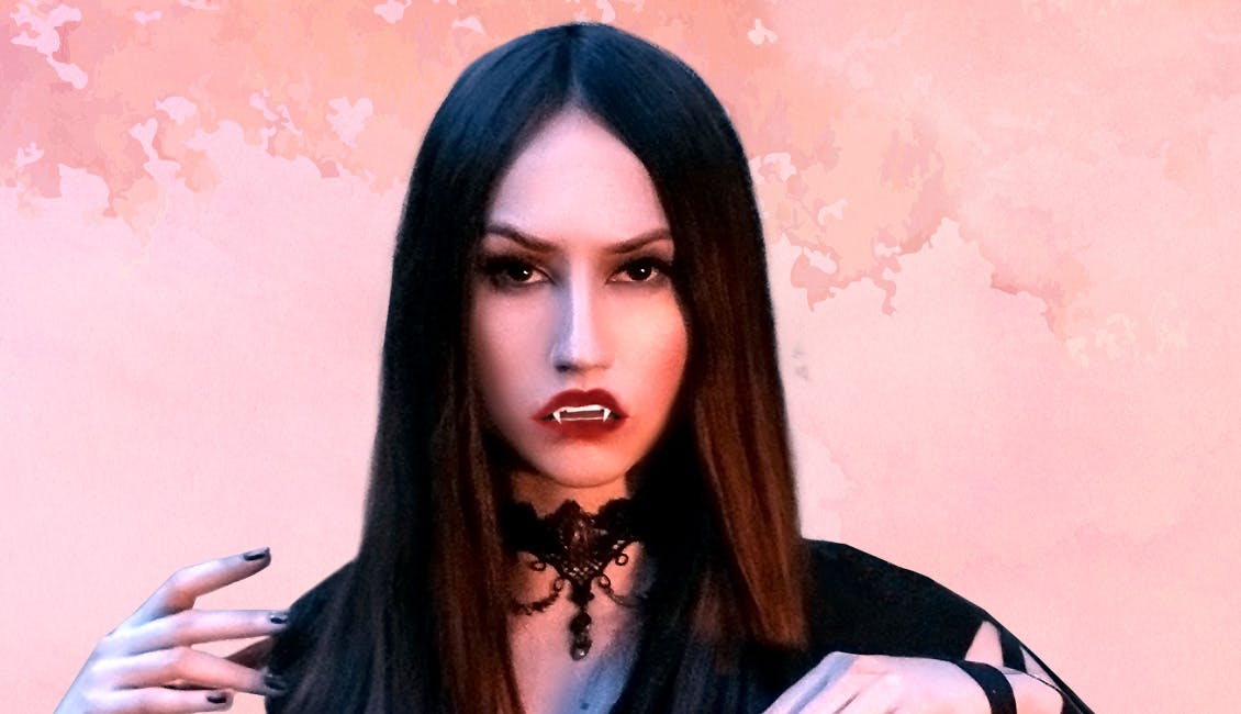 Woman wearing a vampire costume with sleek dark hair