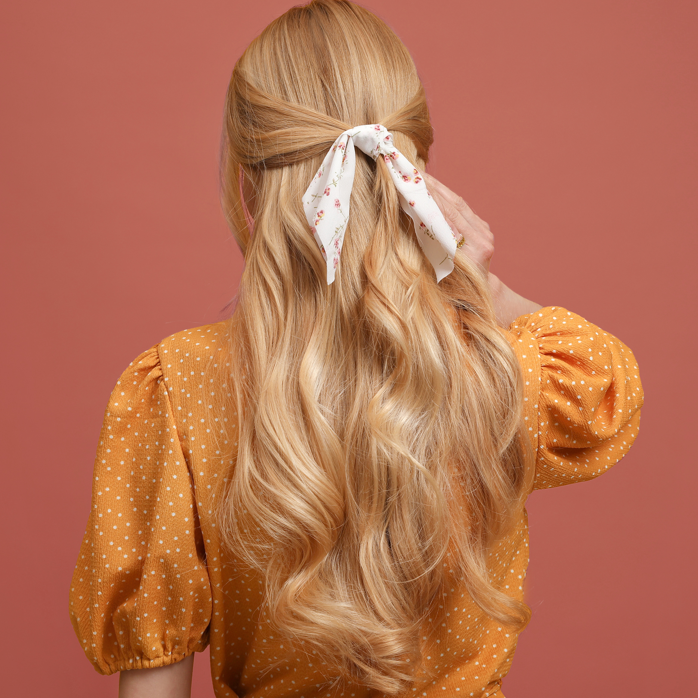 Woman with blonde hair tied in a bow. 