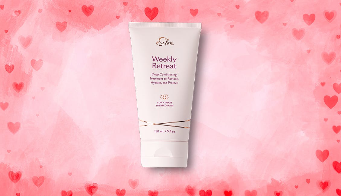 A tube of Weekly Retreat hair mask with pink and red hearts in the background. 