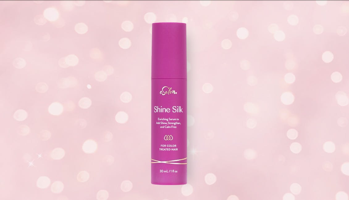 Shine Silk shine serum with sparkling lights behind it.
