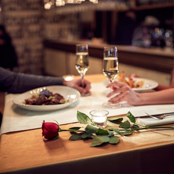 Two people sharing dinner on a romantic date. 