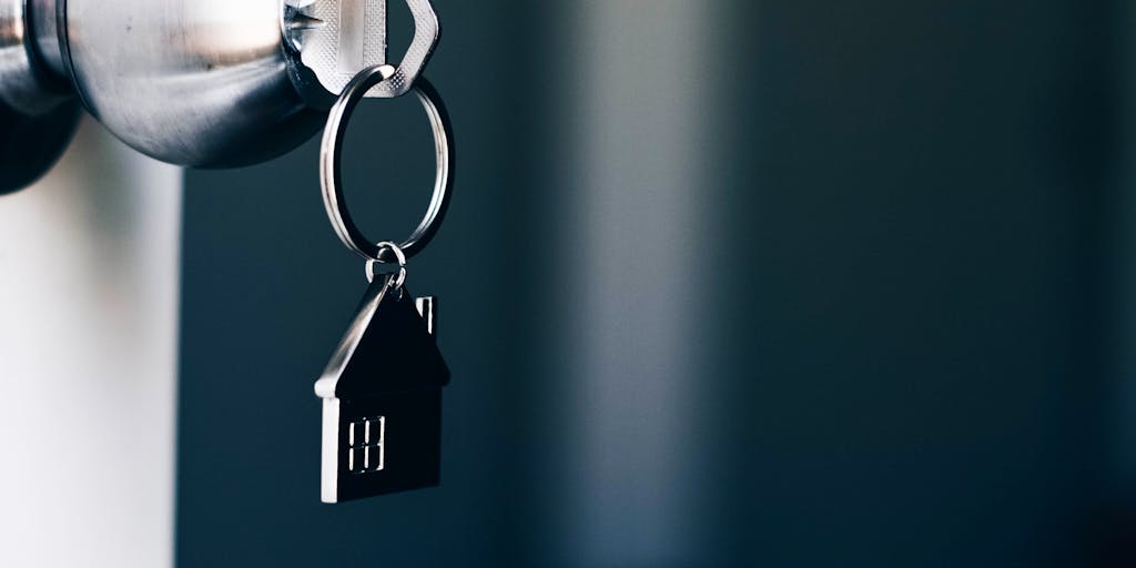 Property Concept, Home key with metal house keychain in keyhole