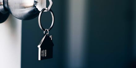 Property Concept, Home key with metal house keychain in keyhole