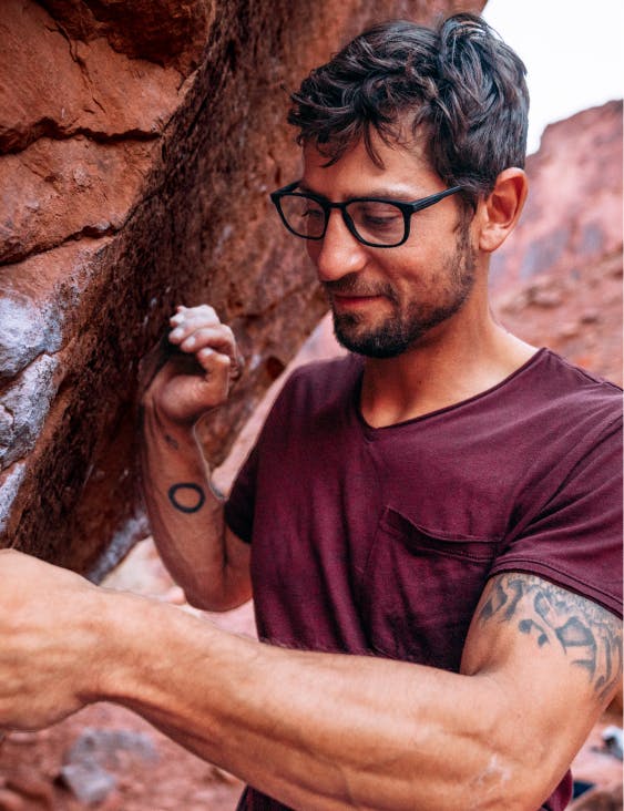 Man rock climbing wearing ROKA eyeglasse