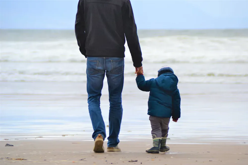 Adult and child on beach