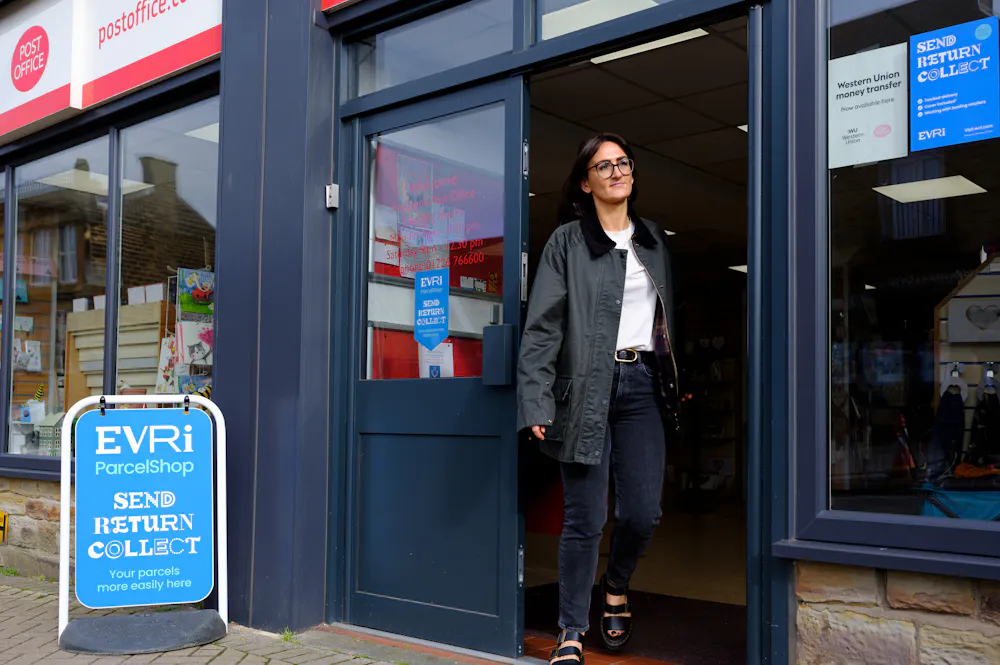 Woman leaving a Post Office ParcelShop