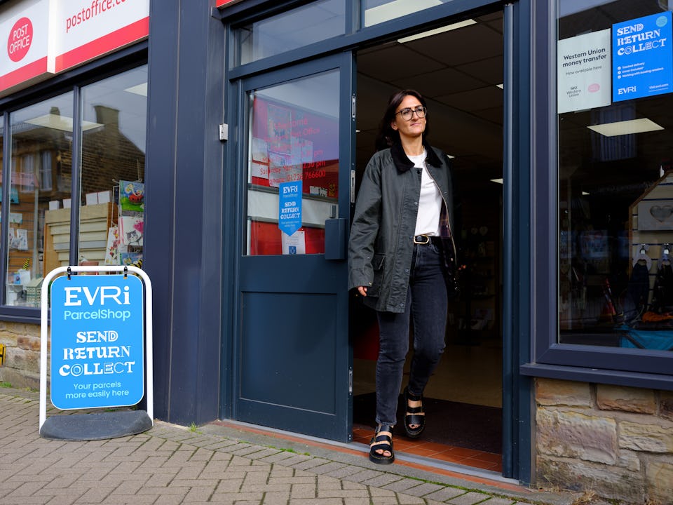 Woman leaving a Post Office ParcelShop