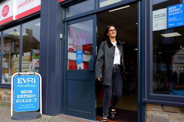 Woman leaving a Post Office ParcelShop