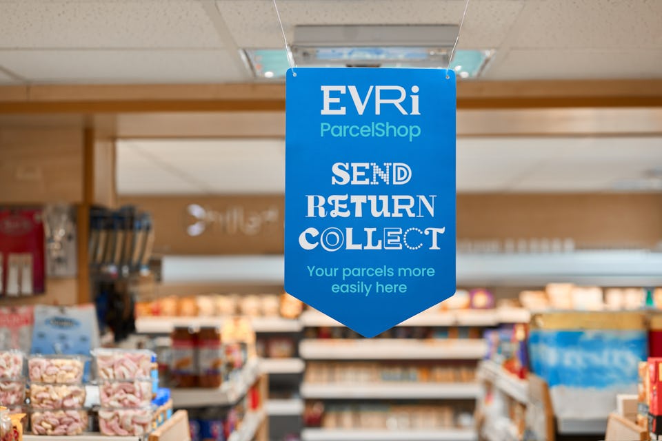 blue hanging parcelshop sign in super market