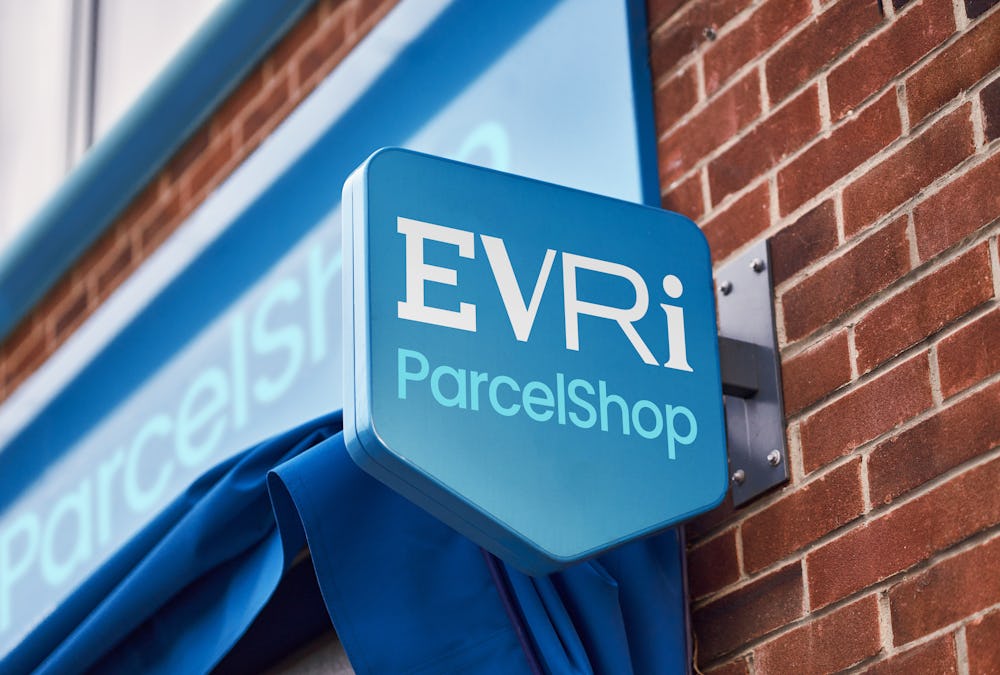 Photo of a blue evri parcelshop sign outide local shop