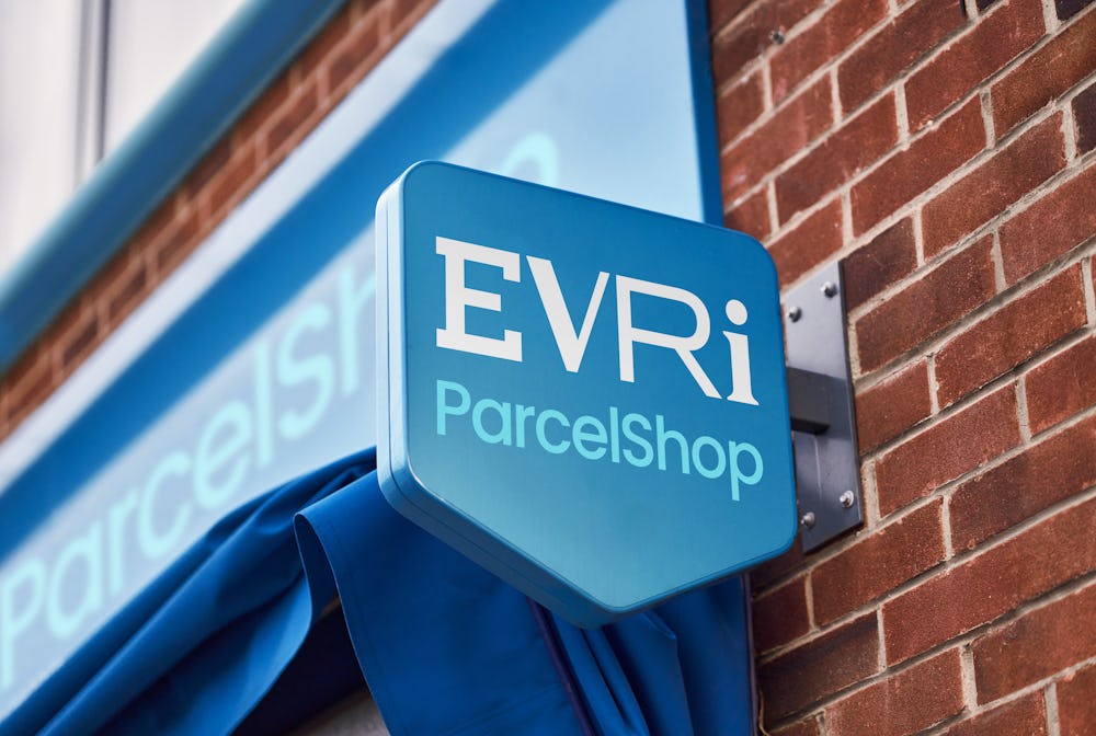 blue evri parcelshop sign outide local shop